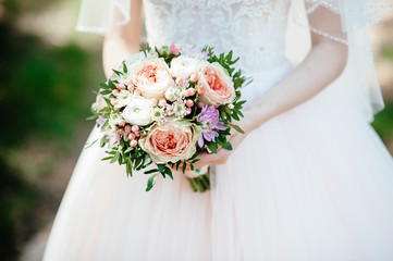 bride holding a bouquet of flowers in a rustic style, wedding bouquet. Soft focus
