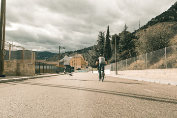 Extreme urban sports concept .Young people with bmx bicycles and skateboards on the street