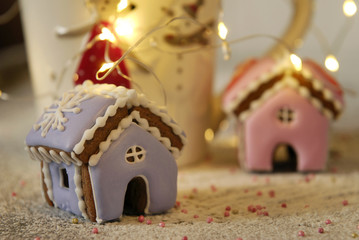 Christmas miniature ginger house, garland and a cup.