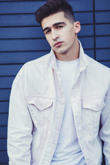 close-up portrait of a fashionable man in a white jacket and t-shirt
