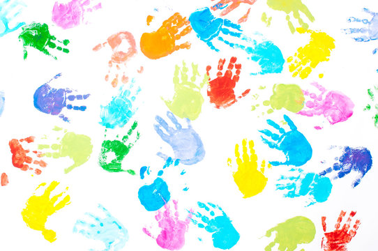Multicolored kids handprints on white background