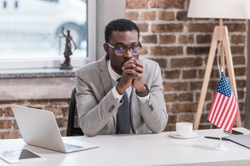 African american businessman sitting at desk modern office