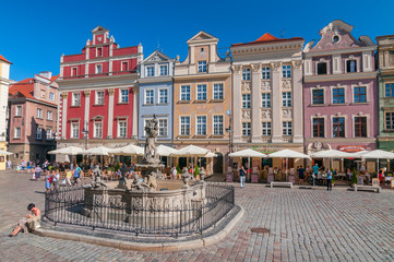 Facades of old houses and fountain on the old Market Square in Poznan, Poland.