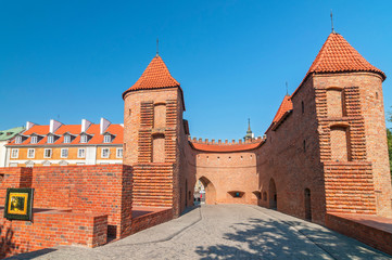 Towers and red brick walls of the historical Warsaw Barbican fort, Poland.