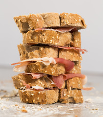 tiered sandwich made with with rye bread and ham