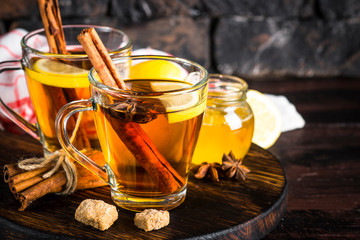 Autumn hot tea with lemon and spices