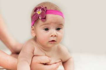 very beautiful baby learns to crawl, he has saliva on an isolated background