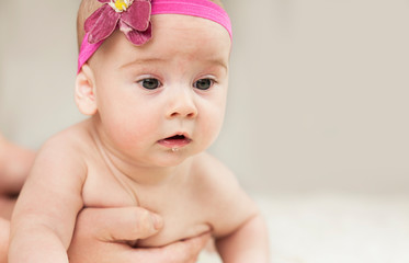 very beautiful baby learns to crawl, he has saliva on an isolated background