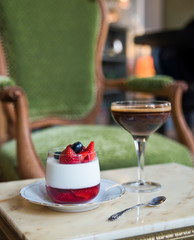 Pana kota dessert and Belgian chocolate on a marble table on a vintage chair
