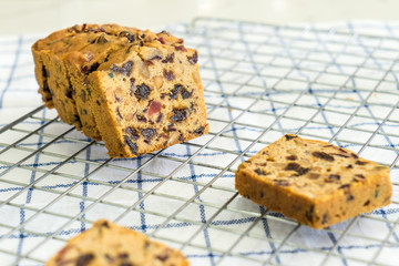 delicious sliced fruit cake with mixed fruit  on grate and fubric