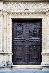 Entrance door of an ancient building with elegant wrought decorations