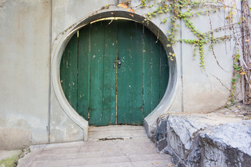 Round green fantasy door in the wall