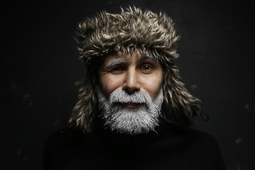 Santa Claus hipster / portrait of a fashionable modern Santa, young man with a gray beard, Christmas winter portrait