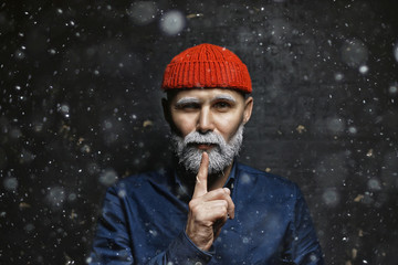 brutal hipster with a gray beard / Christmas winter portrait brutal santa claus, modern trendy guy