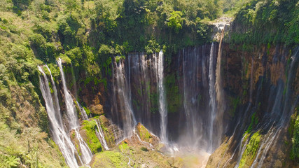beautiful waterfall Coban Sewu in tropical forest, Java Indonesia. aerial view tumpak sewu waterfall in rainforest