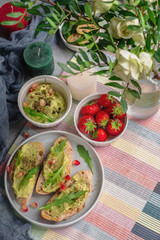 breakfast on the table, fresh snacks and berries, the table is decorated with flowers and candles, copy space