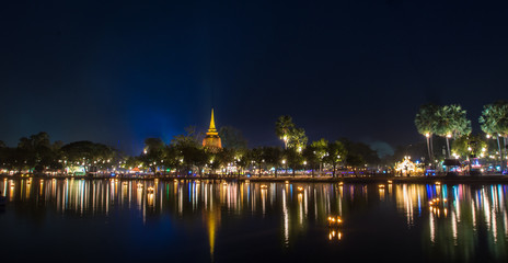 Fototapeta na wymiar Sukhothai historical park at night with lighting in Loy Krathong Festival . Sukhothai, Thailand
