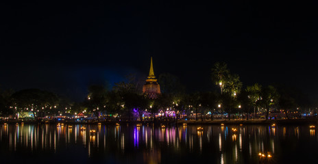 Fototapeta na wymiar Sukhothai historical park at night with lighting in Loy Krathong Festival . Sukhothai, Thailand