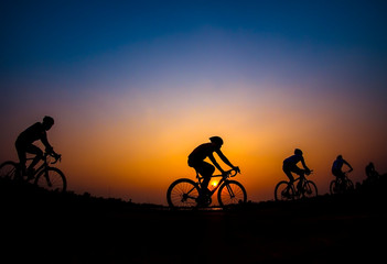 Cyclist in sunset background.