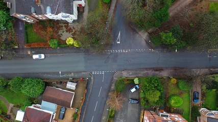 Aerial view of vehicles travelling on roads in the suburbs in a town in the UK