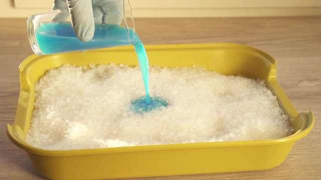blue liquid is absorbed by silica gel crystals