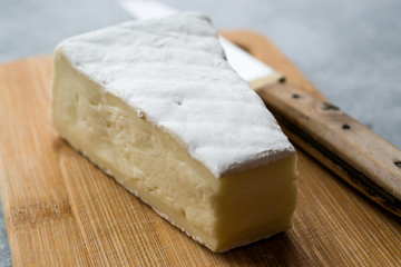 Fototapeta na wymiar Whole Brie Cheese on Wooden Board / Camembert Cheese.