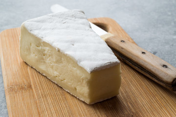Whole Brie Cheese on Wooden Board / Camembert Cheese.
