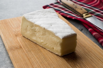 Whole Brie Cheese on Wooden Board / Camembert Cheese.