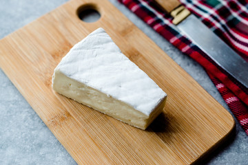 Whole Brie Cheese on Wooden Board / Camembert Cheese.
