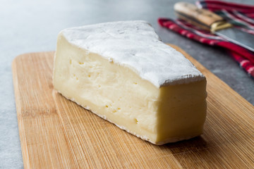 Whole Brie Cheese on Wooden Board / Camembert Cheese.