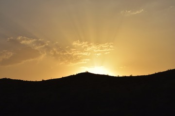 Sunset behind hill