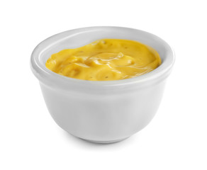 Tasty yellow sauce in bowl on white background