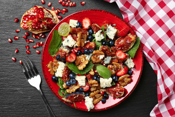 Delicious fresh salad with walnuts on plate