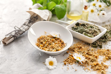 Aromatic dried flowers with herbs on light table