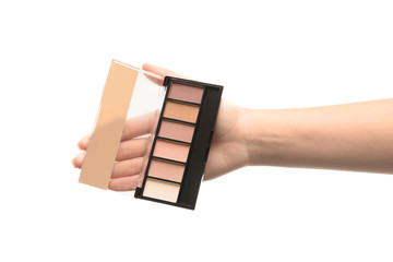 Woman holding eyeshadows on white background