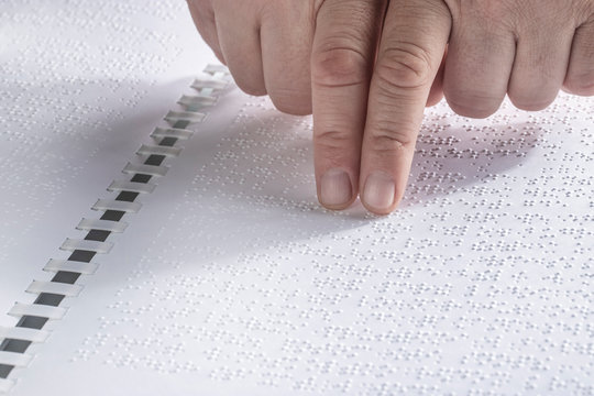 Hand Of A Blind Person Reading Some Braille Text Touching The Relief.