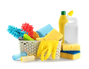 Basket with cleaning supplies on white background