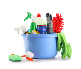 Basin with cleaning supplies on white background