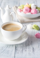 Cup of coffee with colored meringues