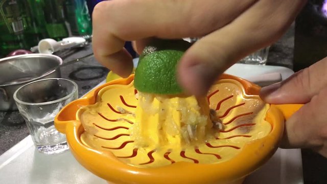 Squeezing lemon with lemon reamer