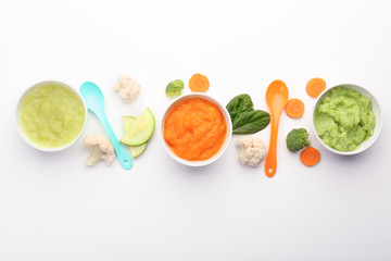 Flat lay composition with healthy baby food on white background