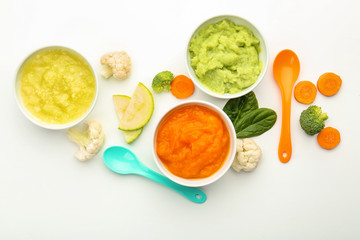 Flat lay composition with healthy baby food on white background