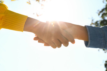 People shaking hands outdoors