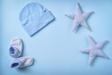 Baby clothes and toys on color background, flat lay