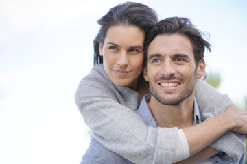  Portrait of gorgeous couple outdoors piggybacking