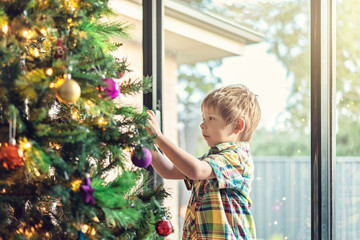 Boy decorating Christmas tree