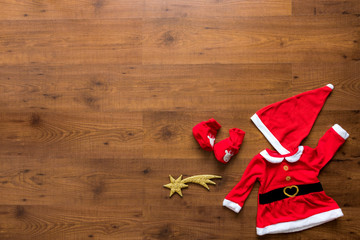 Obraz na płótnie Canvas Christmas ornaments including stars, socks and christmas dress over wooden background
