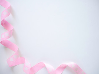Pink curly ribbon on a  white