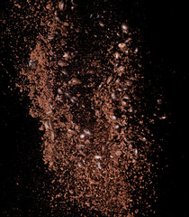Fototapeta na wymiar Coffee powder and coffee beans splash or explosion flying in the air