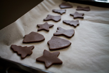 Christmas raw gingerbread cookies on baking tray.
